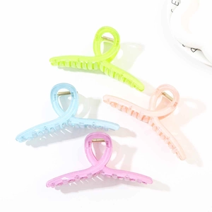 Close-up of four colorful wavy hair claw clips in translucent pastel shades for women