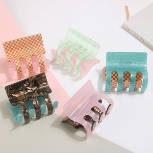 Detailed set of five large acetate hair claws featuring checkers and marble patterns