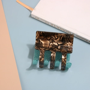 Close-up of a large tortoiseshell hair claw clip with a mint green inner lining