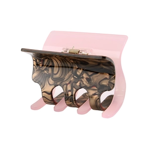 Close-up of pink and marble brown acetate hair claw clip with durable metal spring