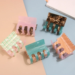 Five assorted acetate hair claws featuring plaid and marble patterns for thick hair