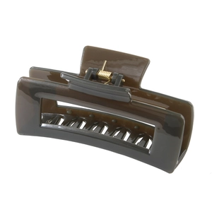 Detail of dark brown rectangular hair claw clip with golden metal spring mechanism