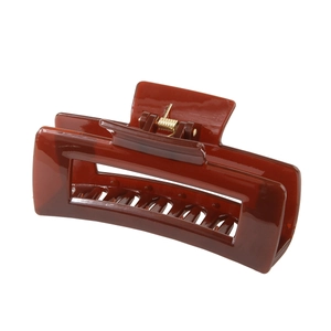 Detail of a dark brown Morandi rectangle hair claw clip with golden metal spring