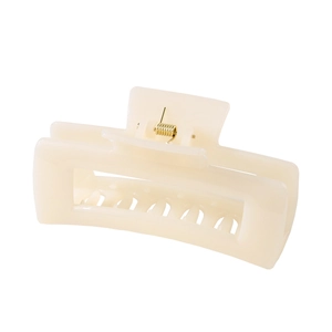 Detailed side view of a cream rectangular hair claw clip with golden metal spring