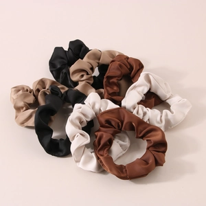 Detailed set of 6 satin silk scrunchies in minimalist earth tone colors on white backdrop