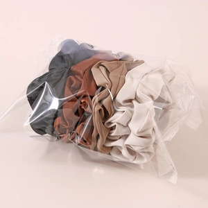 Set of 5 earth-toned satin scrunchies in coffee and cream shades for ponytail styling