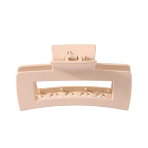 Close-up of a large matte beige rectangle hair claw clip with high-quality metal spring