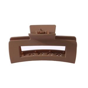 Macro detail of large matte khaki rectangular hair claw clip with a strong metal spring