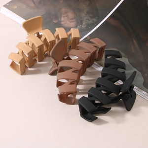 Set of three large matte N-shaped hair claw clips in beige, tan, and black colors