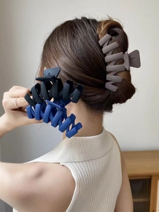 Close-up of matte large hair claw clips in navy, black and taupe for secure hair styling
