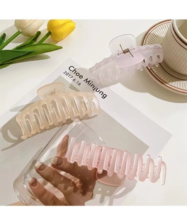 Close-up of matte pastel hair claws with tulip and coffee setup for daily styling