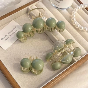 Matte sage green hair claw clips set including large shark clip and small ball clips