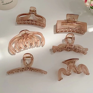 Detail of 6 amber matte hair claws in various shapes for elegant hair styling