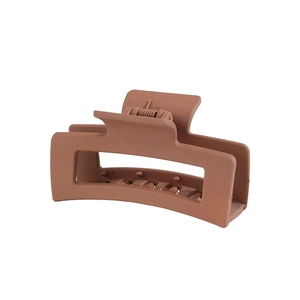 Close-up of matte dark brown rectangular hair claw clip with durable metal spring