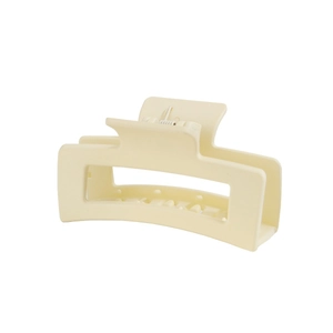 Detailed side view of a large matte beige rectangular claw clip for thick hair styling