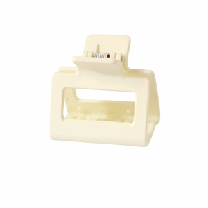 Macro detail of creamy matte rectangular hair claw clip with strong metal spring