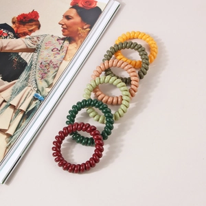 Set of 6 spiral telephone wire hair ties in various colors like olive green and burgundy