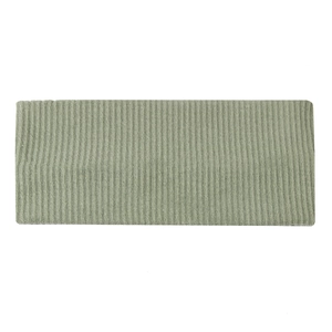 Detailed macro view of the grass green ribbed knit fabric and wide headband texture