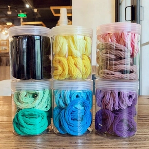 Colorful high-elastic seamless hair ties in jars with ribbed texture and vibrant gradients