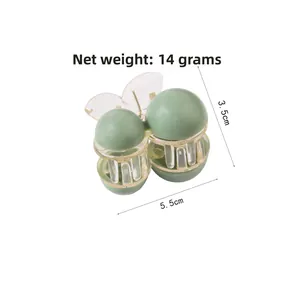 Detail view of light green round hair claw clip with dimensions 5.5cm by 3.5cm