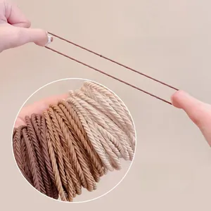Detail of high-elasticity woven hair ties showing stretch durability and earth-tone colors