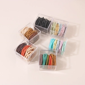 Macro detail of high-elasticity spiral hair ties in various colors and clear gift boxes