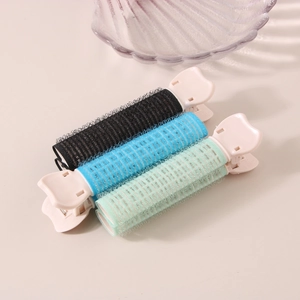 Set di tre bigodini volumizzanti per radici con mollette a farfalla rosa su sfondo chiaro