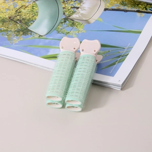 Dettaglio di clip rosa per radici con rulli in velcro verde menta per volume ai capelli