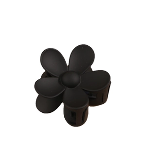 Pince à cheveux fleur noire mate avec un design floral minimaliste sur fond blanc