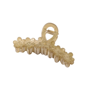Detailed macro view of large translucent yellow resin flower claw clip hair accessory