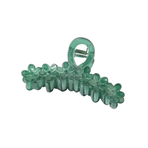 Macro detail of translucent green flower hair claw clip with sturdy metal spring mechanism