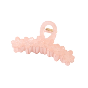 Detailed macro view of a large pale pink floral hair claw clip with golden spring