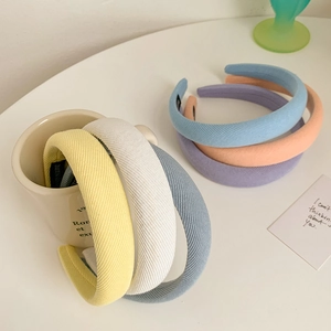 Detailed view of colorful sponge padded headbands with premium twill fabric texture