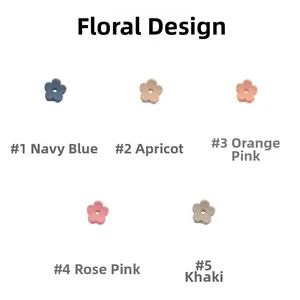 Detail of five matte flower hair clips in navy, apricot, orange pink, rose, and khaki colors