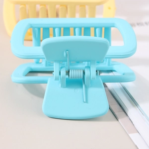 Matte square hair claw clips in blue and yellow with rectangular hollow design for women