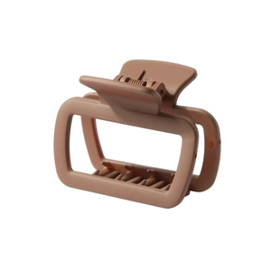 Detail view of a matte brown rectangular hair claw clip with nonslip teeth