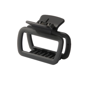 Close-up of matte black rectangular hair claw clip with strong metal spring and non-slip teeth
