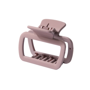 Macro view of matte square hair claw clip in dusty pink with strong metal spring