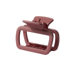 Detail view of square matte hair claw clip in dusty rose with durable metal spring