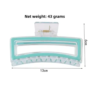 Macro detail of mint green hair claw clip showing 13cm size and sturdy metal spring