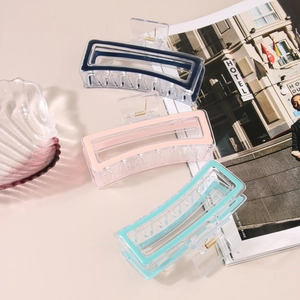 Three large rectangular hollow hair claws in blue pink and green acrylic material