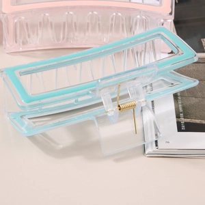 Minimalist candy colored oversized hair claws in pink and mint green transparent resin