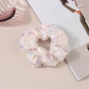 Detail of white mesh organza scrunchie with purple floral prints and 3D dots