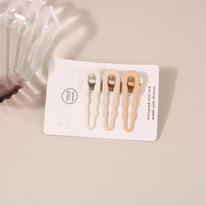 Three-piece set of matte wavy hair clips in cream, beige, and khaki colors for women