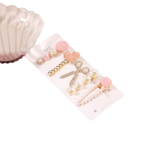 Lot de barrettes à perles roses avec motifs cœur et nœud sur carte de présentation