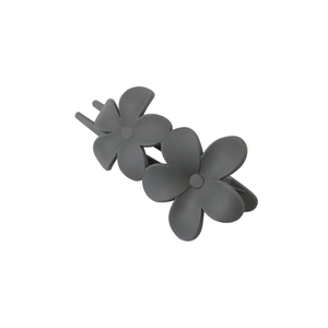 Detail view of a matte grey flower hair claw clip with double petal design on white background