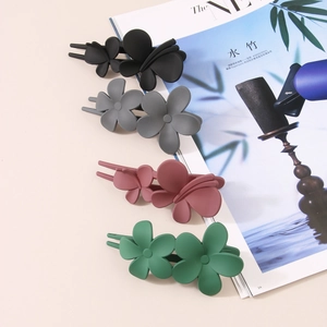 Matte floral and butterfly hair clips in black, grey, pink, and green colors
