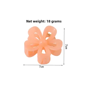 Detailed view of a 7cm peach pink flower hair claw clip weighing 18g with gold spring