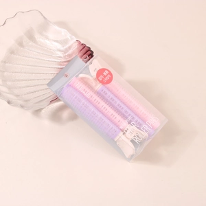 Detail shot of pink and purple hair roller pins for styling roots and bangs