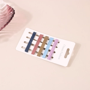 Close-up of 20 pieces colorful candy-style hairpins on a white display card